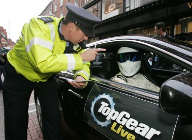 A member of the Gardaí cautioning the Stig.