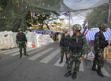 Thai soldiers guard outside an area where anti-government protesters occupy today.