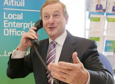 Taoiseach Enda Kenny on the phone, presumably to investors.