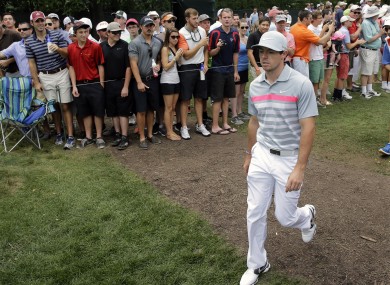Rory McIlroy walks past the gallery on the eighth hole during the final round of play.