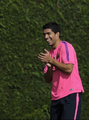 Suarez enjoys a joke during training.