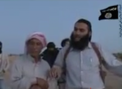 In the video, an Islamic State commander stands over the father of a woman accused of adultery.