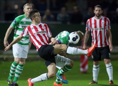 Derry's Michael Duffy gets a foot in ahead of Conor Kane.