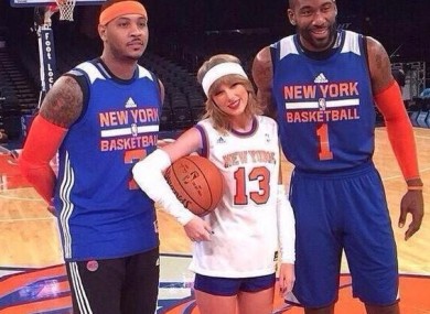 Taylor Swift with an unimpressed Carmelo and a beaming Amar'e Stoudemire.