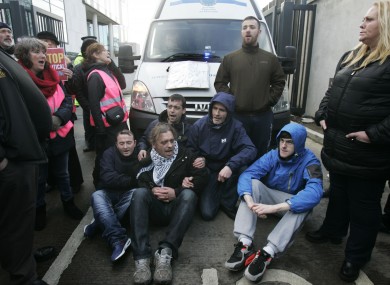 Group of anti water charge supporters block a prison van leaving the courts yesterday.
