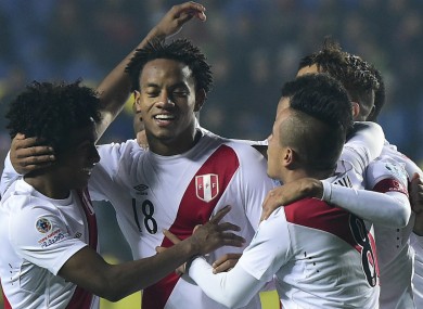 Peru forward Andre Carrillo celebrates with teammates.
