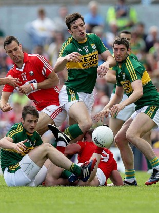 Kerry and Cork players battle for possession.