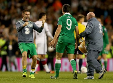 Ya beauty! Keane celebrates with goal hero Shane Long after Ireland's win against Germany.