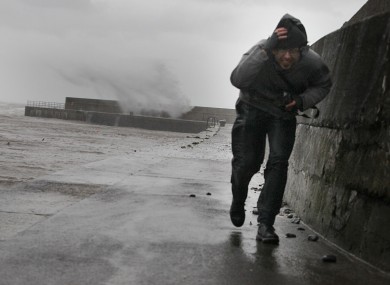 File photo: Stefano Fedele from Italy runs from waves created by Storm Frank winds on Bray Harbour earlier this month.