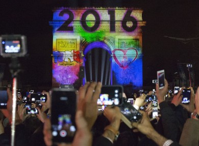 People celebrate the new year in front of the Arc de Triomphe in Paris, France.