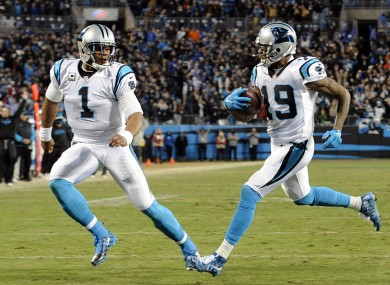 Ted Ginn Jr scores the game's first touchdown as Cam Newton watches on.