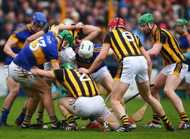A scrum develops for possession between Kilkenny and Tipperary players.