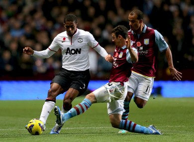 Enda Stevens tackles Manchester United's Antonio Valencia while playing for Aston Villa in 2012.