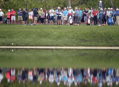 Rory McIlroy, right, of Northern Ireland, watches his tee shot on the 12th hole during the second round of the Arnold Palmer Invitational golf tournament.