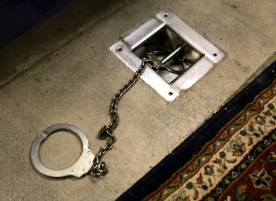 A foot shackle is bolted to a floor covered by a decorative carpet, inside Interview Room 1, where prisoners are interrogated, inside Cell Block A at Camp 5 maximum security prison, Guantanamo Bay US Naval Base, Cuba