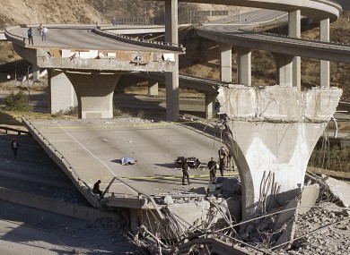A 1994 file photo of the body of a police officer on the State Highway 14 overpass in Southern California following the Northridge earthquake.