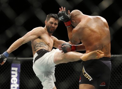 Carlos Condit lands a body-kick during his welterweight title bout against champion Robbie Lawler in January.