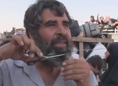 Man cuts beard during celebrations on the street.