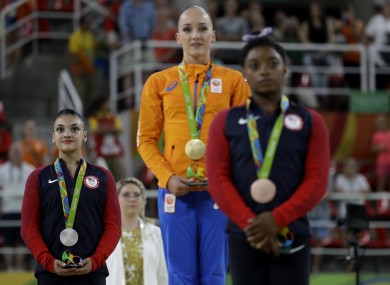 Netherlands' Sanne Wevers, centre, gold, United States' Lauren Hernandez, left, silver, and United States' Simone Biles, right, stand after receiving their medals for balance beam during the artistic gymnastics women's apparatus final.