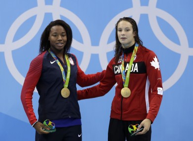 Gold medal winners United States' Simone Manuel and Canada's Penny Oleksiak, right, pose for a photograph during the medal ceremony.