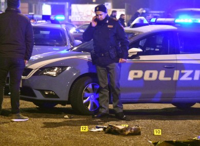 Police at the scene in Milan where the suspect was shot dead.