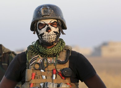 member of Iraq's elite counterterrorism forces stands as they advance towards the city of Mosul, Iraq, last October.