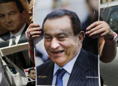 A supporter holds up an image of Mubarak.