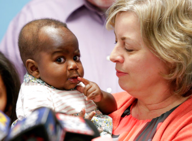 Foster mother Nancy Swabb holds Dominique