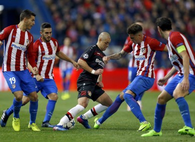 Leverkusen's Javier Hernandez is swarmed by four Atleti players.