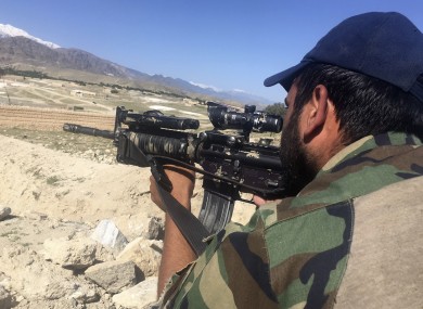 An Afghan commando stands guard at the Pandola village of near the site of the US forces' bombing in Achin district of Jalalabad.