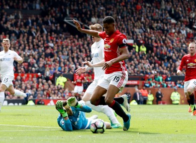 Manchester United's Marcus Rashford takes a tumble in the Swansea box.