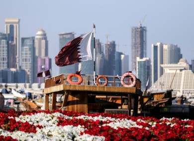 The Qatari flag waves in front of the capital, Doha.