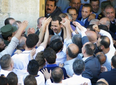 Assad (centre) meets with supporters.