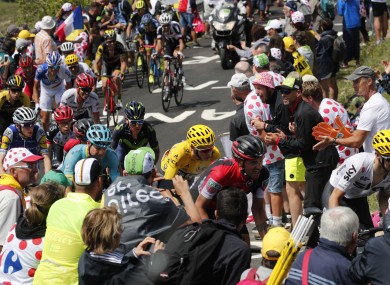 Britain's Chris Froome, wearing the overall leader's yellow jersey, is followed by Denmark's Jakob Fuglsang, Australia's Richie Porte, Colombia's Nairo Quintana, and Ireland's Daniel Martin, far left in blue and yellow, as he climbs towards Grand Colombier pass during the ninth stage of the Tour de France cycling race.