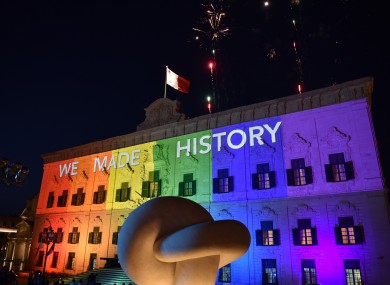 The Maltese Prime Minister's office is lit up in rainbow colours with fireworks exploding after parliament voted in favour of same-sex marriage in Valletta, capital of Malta last night.