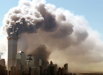Clouds of smoke rise from the burning upper floors of the World Trade Center in New York on 11 September 2001