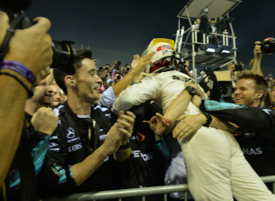 Mercedes' British driver Lewis Hamilton celebrates with teammates after winning the Formula One Singapore Grand Prix in Singapore.