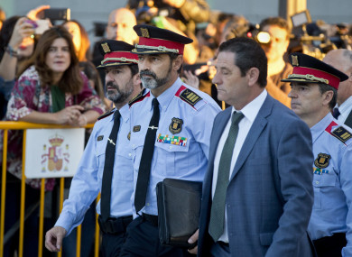 Catalan regional police chief Josep Luis Trapero, second left, arrives at the national court in Madrid, Spain.