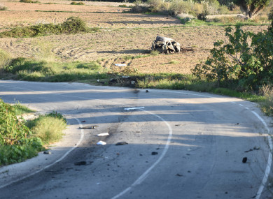 The wreckage of the car of investigative journalist Daphne Caruana Galizia lies next to a road near the town of Mosta.