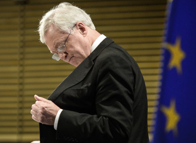 The UK's Secretary of State for Exiting the EU, David Davis reaches inside his inside pocket.