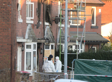 Forensic officers at the scene of the fire.