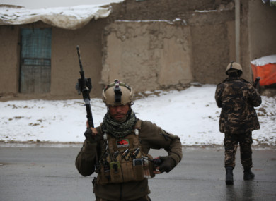 Afghan security personnel cordon off the site of the attack on a military university in Kabul, the capital of Afghanistan.