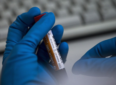 In this Tuesday, May 24, 2016 file photo an employee of the Russia's national drug-testing laboratory holds a vial in Moscow, Russia. A Russian doping whistleblower’s lawyer says Fifa has made no attempt to gain information about “many” footballers embroiled in the widespread conspiracy.