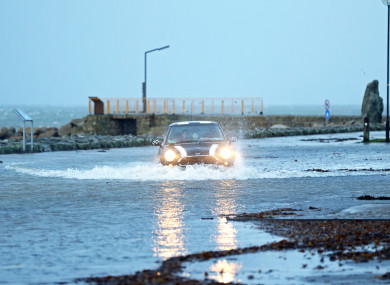A car drives through a flooded car park in Salthill, Galway.