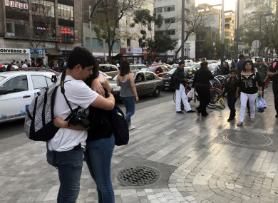 People gathering on a street after a tremor was felt in Mexico City