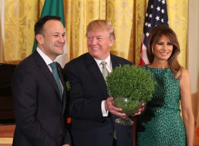 Taoiseach Leo Varadkar presents US President Donald Trump with a bowl of shamrock as Melania Trump looks on during the annual presentation ceremony at the White House.