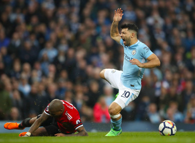 Aguero is caught late by Man United's Ashley Young during the recent derby.
