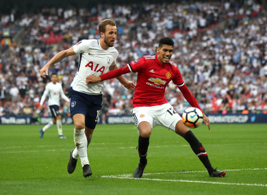 Smalling protects the football from Harry Kane.