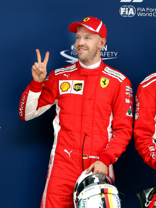 First-placed Ferrari's driver Sebastian Vettel of Germany poses for photos after the qualifying of Formula 1 2018 Chinese Grand Prix in Shanghai.
