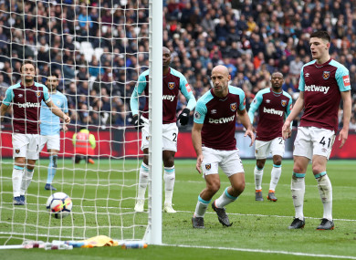 Rice (right) and the West Ham players watch the own goal bounce in.